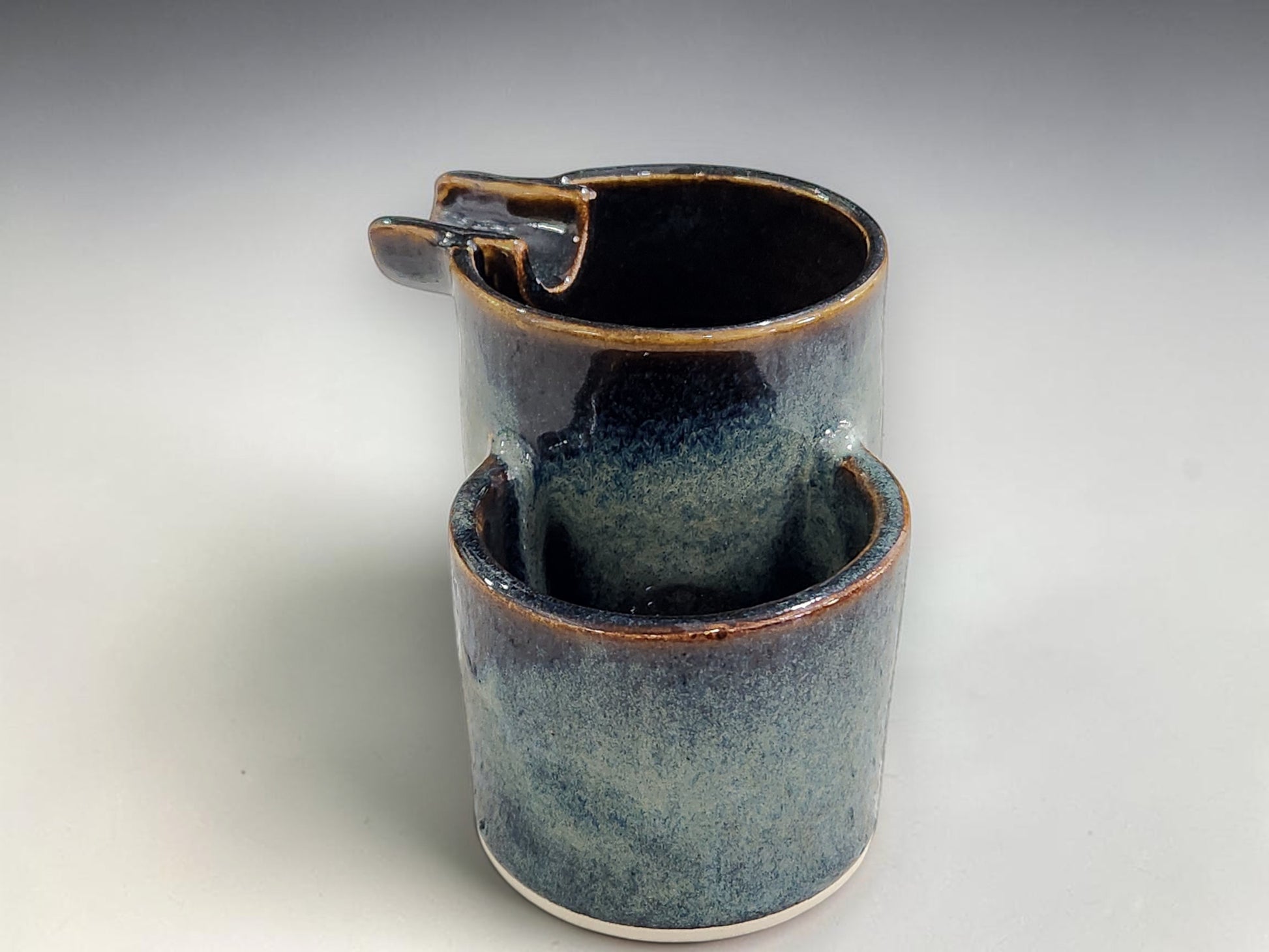 Handmade ashtray in sculptural double form with glossy dark rim and blue glaze