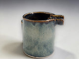 Close view of ceramic ashtray showing blue blushed Tenmoku glaze detail