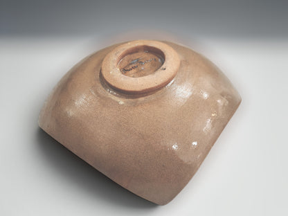 underside of a Handmade ceramic serving bowl with carved geometric motifs and earthy natural glaze