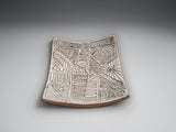 Artisan ceramic bowl-plate featuring intricate hand-carved patterns in natural terracotta clay