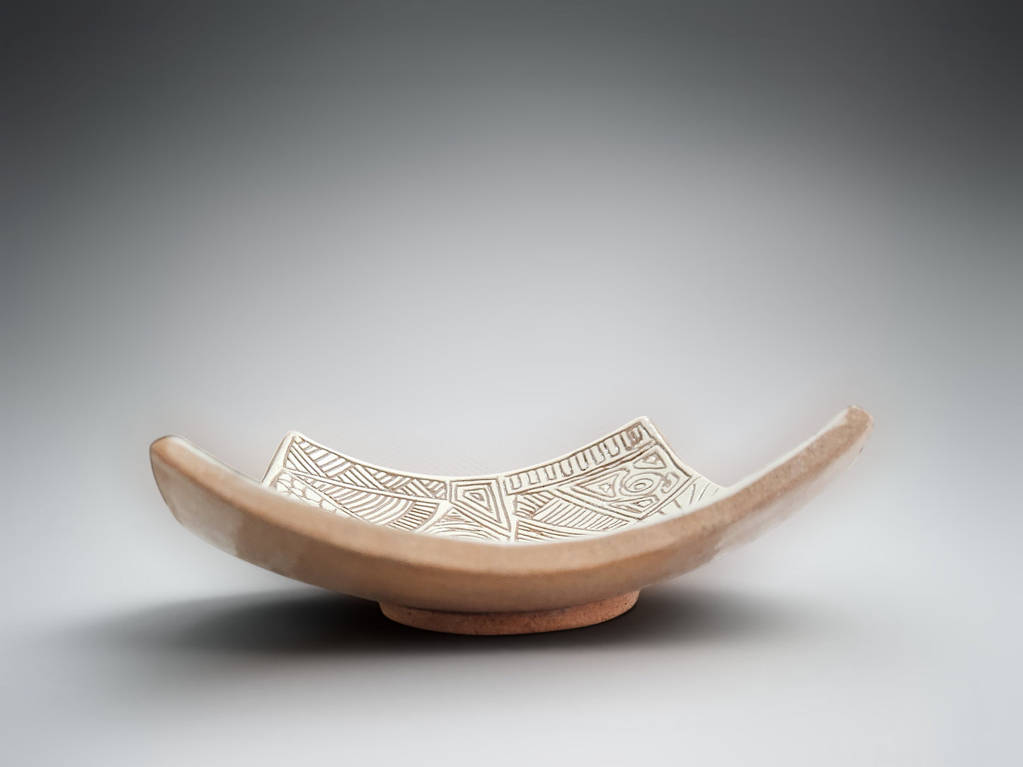 Decorative terracotta trinket bowl with sculptural draped edges and etched surface design