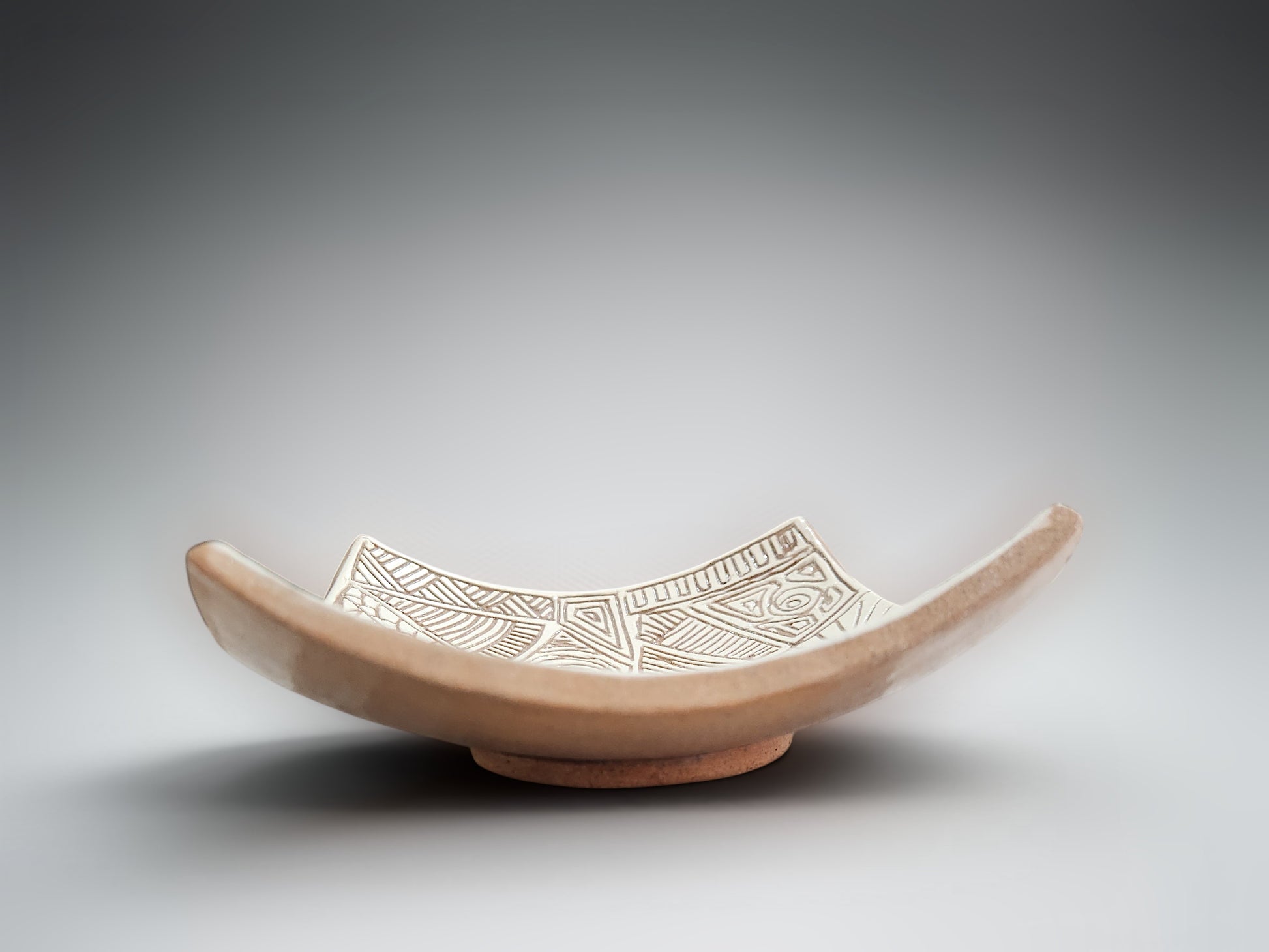 Decorative terracotta trinket bowl with sculptural draped edges and etched surface design