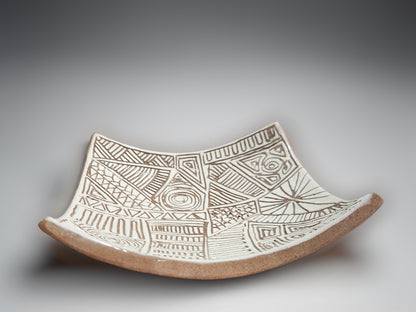 Handmade ceramic bowl-plate with carved white slip detailing and organic curved form