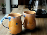 Wheel-thrown mug pair with curved handles