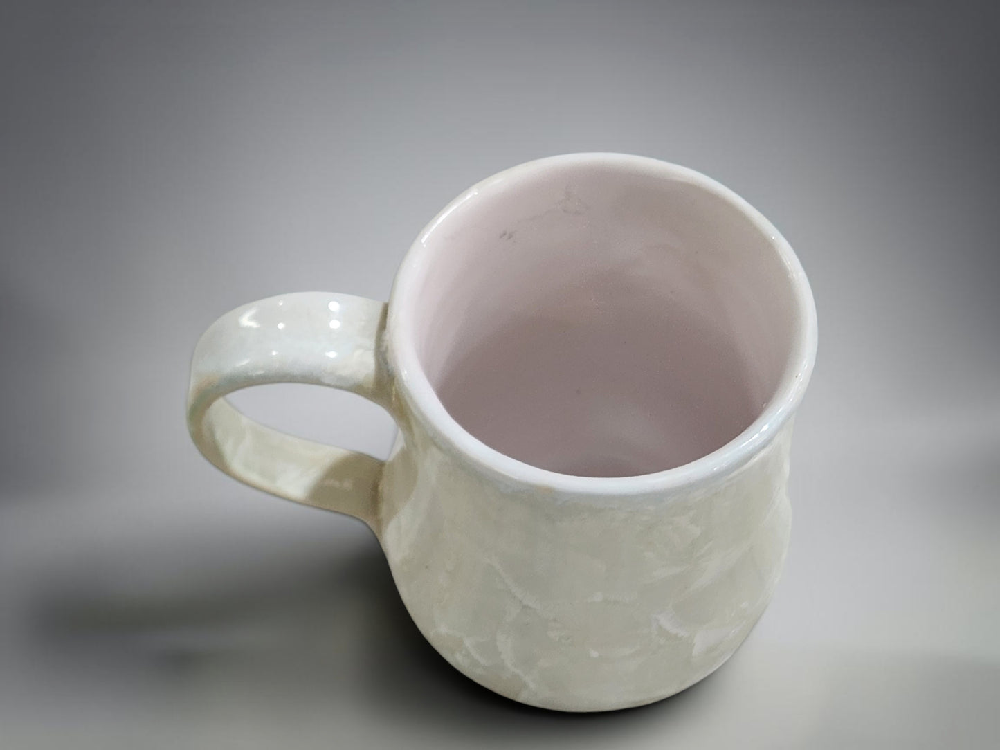 Wheel-thrown porcelain coffee mug with rounded handmade shape