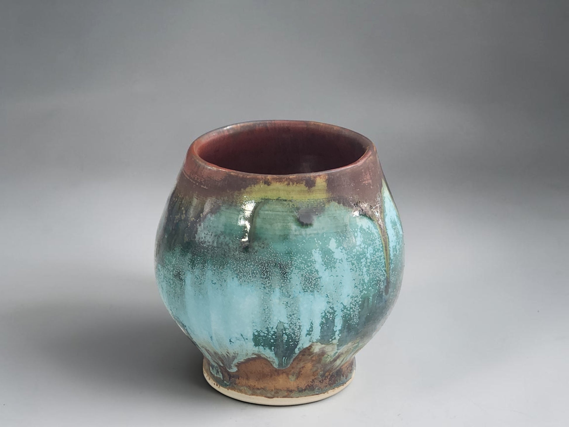 Handmade ceramic tea cup with earthy turquoise and brown glaze from the Bush Creek Earth Collection